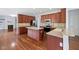 Updated kitchen boasts stainless appliances, an island, and wood cabinets at 12997 Bartlett Dr, Fishers, IN 46037