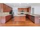 Spacious kitchen with wood cabinets, large island, stainless steel appliances, and tile backsplash at 12997 Bartlett Dr, Fishers, IN 46037
