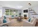 Staged living room features a fireplace, open shelving, and comfortable seating at 12997 Bartlett Dr, Fishers, IN 46037