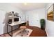 Office space with white walls, hardwood floors, desk, shelving, and a comfortable chair at 12997 Bartlett Dr, Fishers, IN 46037
