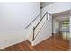 Foyer with hardwood floors, staircase with carpet runner, and white wainscoting at 12997 Bartlett Dr, Fishers, IN 46037
