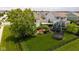 Expansive backyard showcasing a well-maintained lawn, mature trees, a patio area, and a trampoline at 12998 Silbury Hill Way, Fishers, IN 46037