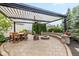 Outdoor patio featuring pergola, a dining table, a stone fire pit, and seating at 12998 Silbury Hill Way, Fishers, IN 46037
