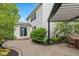 Charming backyard patio with stone pavers, manicured landscaping, and a covered pergola for outdoor entertaining at 12998 Silbury Hill Way, Fishers, IN 46037