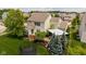 Aerial view of the backyard features a lush lawn, pergola, mature trees, and meticulously landscaped garden beds at 12998 Silbury Hill Way, Fishers, IN 46037