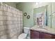 Bathroom showcasing a toilet, sink with gray granite countertop, and a patterned shower curtain at 12998 Silbury Hill Way, Fishers, IN 46037