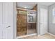 Bathroom with glass-enclosed shower featuring tile surround and mosaic tile floor, plus a convenient shower niche at 12998 Silbury Hill Way, Fishers, IN 46037