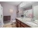 Bathroom featuring a dual sink vanity, granite countertop, tiled floor, and colorful shower curtain at 12998 Silbury Hill Way, Fishers, IN 46037