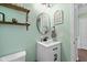 Well-lit bathroom featuring a modern sink, updated fixtures, and mint green walls at 12998 Silbury Hill Way, Fishers, IN 46037
