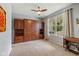 Cozy bedroom featuring a built-in Murphy bed with ample storage and a ceiling fan at 12998 Silbury Hill Way, Fishers, IN 46037