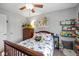 Cozy bedroom featuring a toddler bed with stuffed animals, dresser, and a window with natural light at 12998 Silbury Hill Way, Fishers, IN 46037
