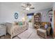 Charming bedroom featuring shiplap accent wall, plush carpet, and a cozy reading nook with armchair and bookcase at 12998 Silbury Hill Way, Fishers, IN 46037