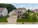 Charming two-story home with a three-car garage, landscaped yard, and a welcoming front porch at 12998 Silbury Hill Way, Fishers, IN 46037