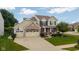 Charming two-story home with a three-car garage, landscaped yard, and a welcoming front porch at 12998 Silbury Hill Way, Fishers, IN 46037