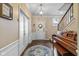 Elegant foyer featuring hardwood floors, a staircase, a piano, and a decorative rug at 12998 Silbury Hill Way, Fishers, IN 46037