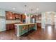 Spacious kitchen featuring a large island with seating, stainless steel appliances, and hardwood flooring at 12998 Silbury Hill Way, Fishers, IN 46037