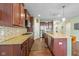 Gourmet kitchen featuring granite counters, tiled backsplash, stainless steel appliances and wood flooring at 12998 Silbury Hill Way, Fishers, IN 46037