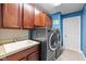 Laundry room with modern washer and dryer, sink, and cabinet storage at 12998 Silbury Hill Way, Fishers, IN 46037