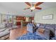 Open concept living and dining area with hardwood floors, comfortable seating, and natural light at 12998 Silbury Hill Way, Fishers, IN 46037