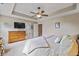 Comfortable main bedroom with tray ceilings, carpeted floors, and a classic wood dresser at 12998 Silbury Hill Way, Fishers, IN 46037