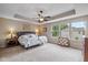 Spacious main bedroom featuring tray ceilings, large windows, and natural light at 12998 Silbury Hill Way, Fishers, IN 46037