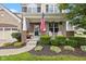 Charming front porch with a patriotic display and comfortable seating, framed by lush landscaping at 12998 Silbury Hill Way, Fishers, IN 46037