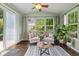 Cozy sunroom featuring ample natural light, comfortable seating, and stylish décor at 12998 Silbury Hill Way, Fishers, IN 46037