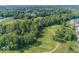 Stunning aerial view of golf course surrounded by lush greenery and serene pond at 13161 Duval Dr, Fishers, IN 46037