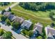 Aerial view of homes featuring golf course, surrounded by lush greenery in a suburban setting at 13161 Duval Dr, Fishers, IN 46037