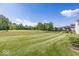 Large, well-maintained backyard with freshly cut grass, ideal for Gathering fun and entertaining at 13161 Duval Dr, Fishers, IN 46037