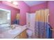 Bright bathroom features a shower/tub combo, single sink vanity, and vibrant pink walls at 13161 Duval Dr, Fishers, IN 46037