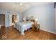 Primary bedroom featuring hardwood floors, neutral walls, and a connected bathroom at 13161 Duval Dr, Fishers, IN 46037