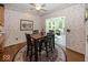 A dining area with wood floors and a view of an enclosed sunroom with lots of windows at 13161 Duval Dr, Fishers, IN 46037