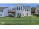 Exterior view of the home with a deck, a well-maintained lawn, and mature landscaping at 13161 Duval Dr, Fishers, IN 46037