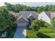 Charming brick home with a well-manicured lawn and mature trees in a peaceful residential neighborhood at 13161 Duval Dr, Fishers, IN 46037