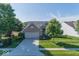 Beautiful brick home with a spacious driveway and lush green lawn under a clear blue sky at 13161 Duval Dr, Fishers, IN 46037