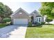 Lovely brick home featuring an attached two-car garage, manicured landscaping, and a welcoming entrance at 13161 Duval Dr, Fishers, IN 46037