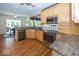 Kitchen area showcases wood cabinets, granite countertops, and stainless steel appliances at 13161 Duval Dr, Fishers, IN 46037