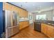 Spacious kitchen featuring stainless steel appliances, wood cabinetry, and granite countertops at 13161 Duval Dr, Fishers, IN 46037