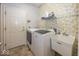 Efficient laundry room with a washer, dryer, and sink for added convenience at 13161 Duval Dr, Fishers, IN 46037