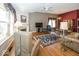 Bright living room featuring hardwood floors, a fireplace, and large windows with decorative drapes at 13161 Duval Dr, Fishers, IN 46037