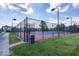 Fenced outdoor tennis court with well-maintained surface and surrounding landscaping at 13161 Duval Dr, Fishers, IN 46037