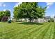 Large grassy backyard includes a play set and entertainment-ready patio area at 1319 Gable Lake Dr, Brownsburg, IN 46112