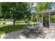 Enjoy the beautiful backyard with a patio, pond, play set, and lush landscaping at 1319 Gable Lake Dr, Brownsburg, IN 46112