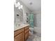Cozy bathroom with a shower-tub combo, a wood vanity and a patterned shower curtain at 1319 Gable Lake Dr, Brownsburg, IN 46112