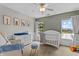 Bright Bedroom with a crib, white furniture and calming colors with view of the lake at 1319 Gable Lake Dr, Brownsburg, IN 46112