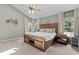 Inviting bedroom with a vaulted ceiling, large bed, ceiling fan, and natural light from windows with decorative curtains at 1319 Gable Lake Dr, Brownsburg, IN 46112