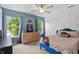 Comfortable bedroom with a ceiling fan, dresser, two windows and space themed decor at 1319 Gable Lake Dr, Brownsburg, IN 46112