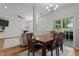 Bright dining area with wood table and chairs adjacent to a living room with fireplace and sliding glass doors to the yard at 1319 Gable Lake Dr, Brownsburg, IN 46112