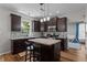 Beautiful kitchen with dark wood cabinets, granite countertops, stainless appliances, and a center island at 1319 Gable Lake Dr, Brownsburg, IN 46112